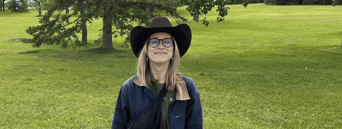 Young woman wearing a wide-brimmed hat and glasses outdoors, representing the KYCK Committee at Katoomba Christian Convention.