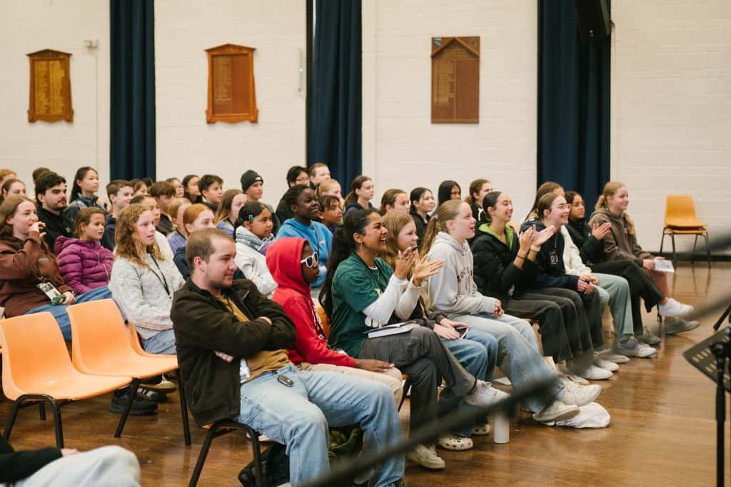 Diverse group of young people attending a Christian event at Katoomba Christian Convention, engaging in worship and listening attentively during a faith-based gathering.