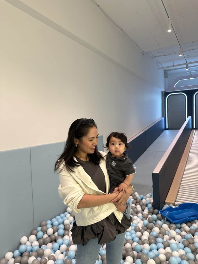 Mother and child enjoying a playful moment at a children's indoor play area, highlighting family bonding and parenting experiences.