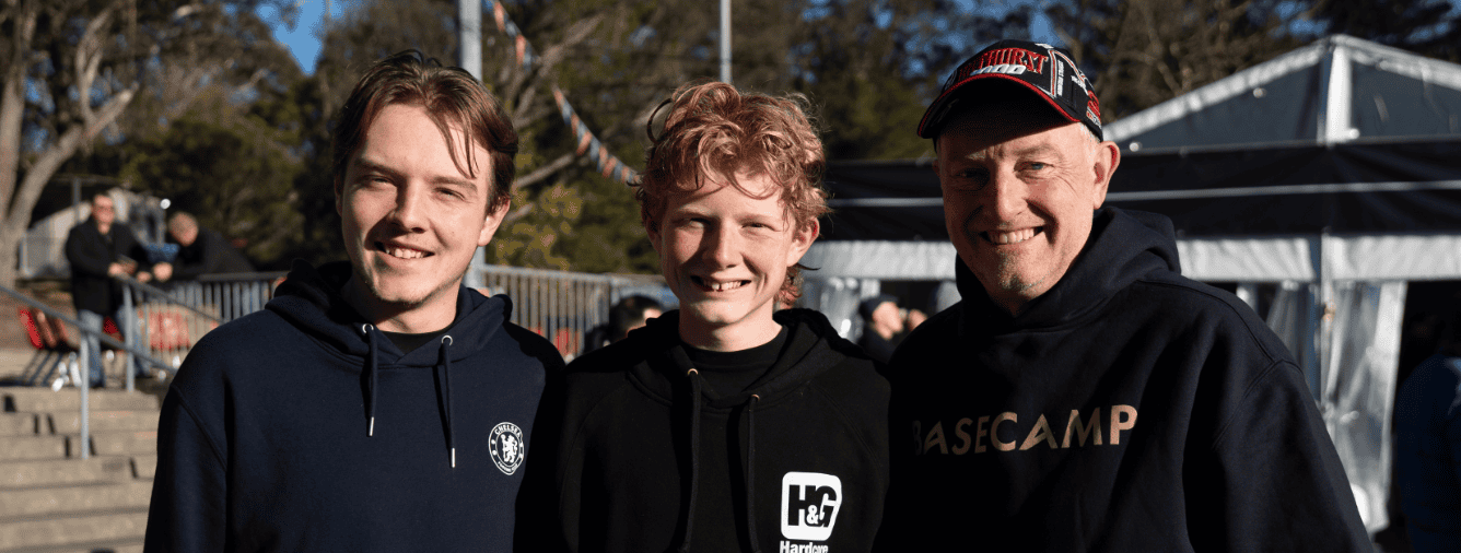 Three men smiling at BASECAMP 2026 event, representing Christian community and fellowship at Katoomba.