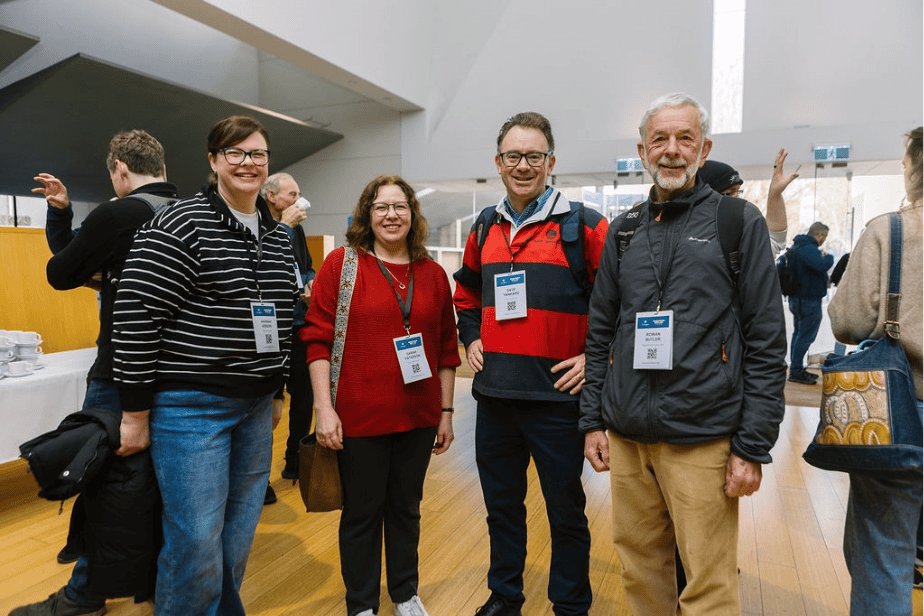 Group of diverse conference attendees smiling and engaging at the Katoomba Christian Convention, showcasing community and faith.