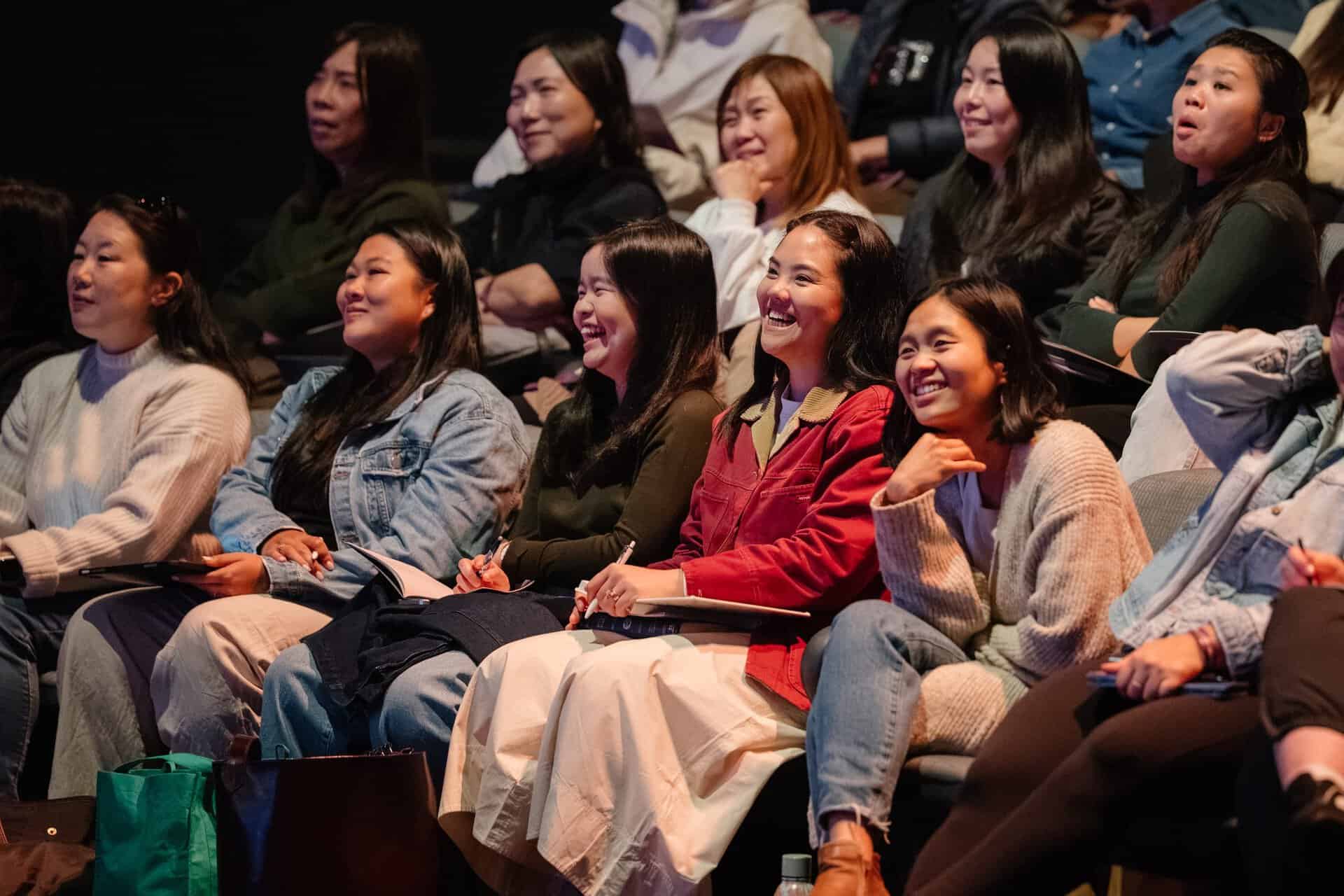 Group of women attending the OneLove conference in Katoomba, engaging and smiling during the event.